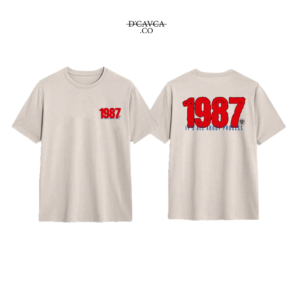Beige t-shirt with '1987' printed on the front and back, featuring the brand 'DCAVCA'.