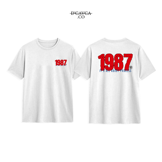 White t-shirt with '1987' printed on the front and back, featuring the brand 'DCAVCA'.