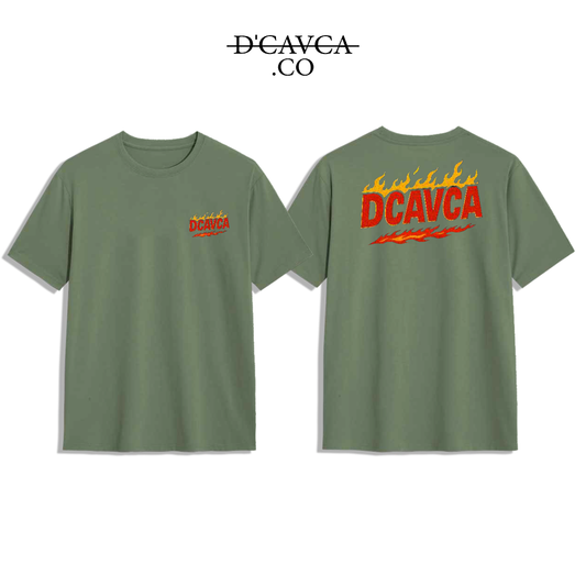 Green t-shirt with 'DCAVCA' logo on front and back, brand name at top.